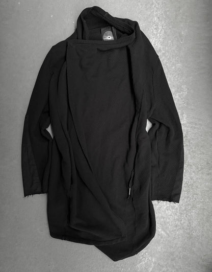 Black hooded garment on a gray surface