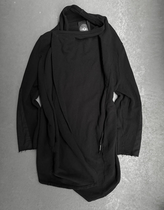 Black hooded garment on a gray surface