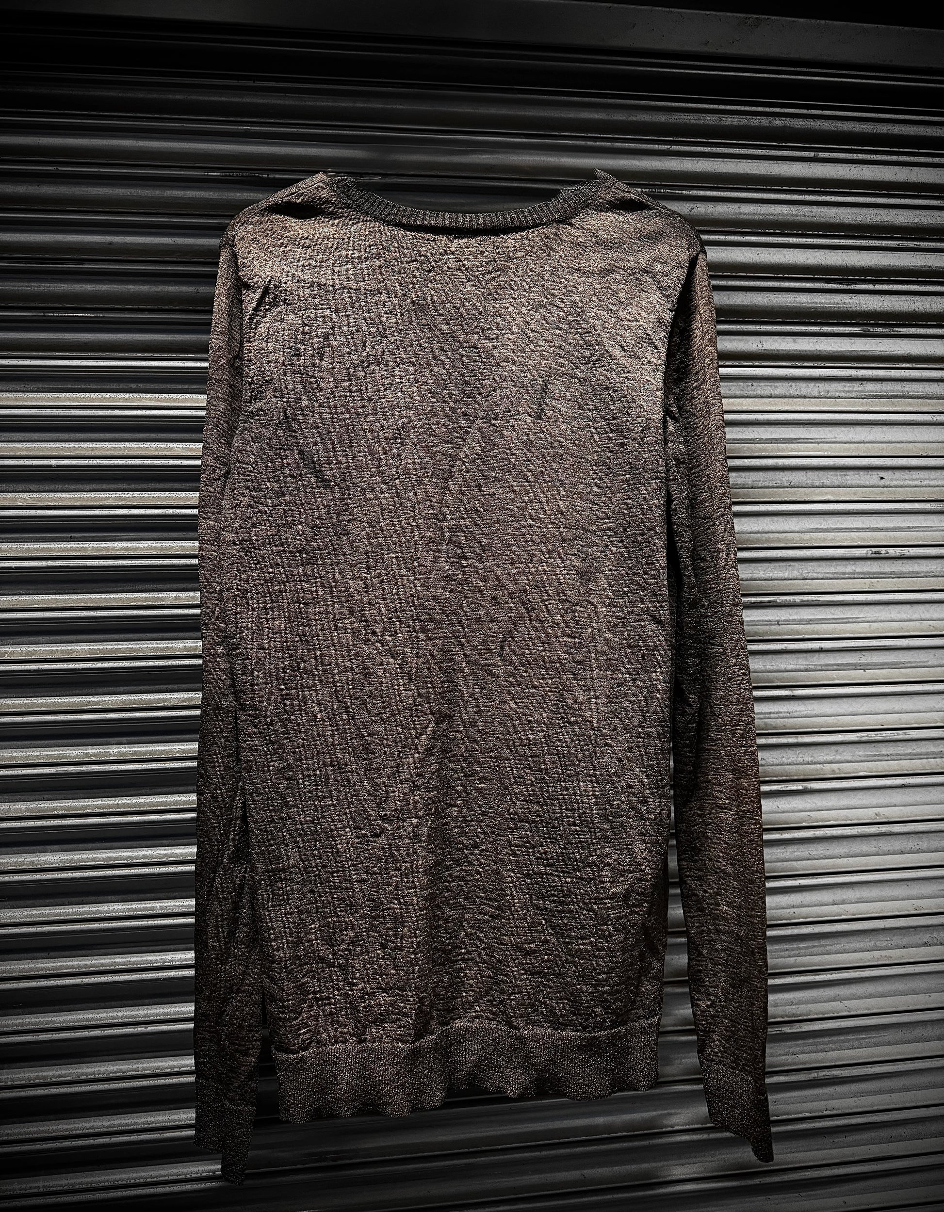 Brown textured sweater on a metallic surface