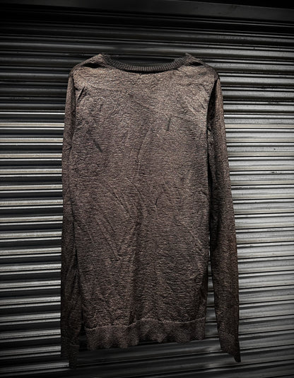 Brown textured sweater on a metallic surface