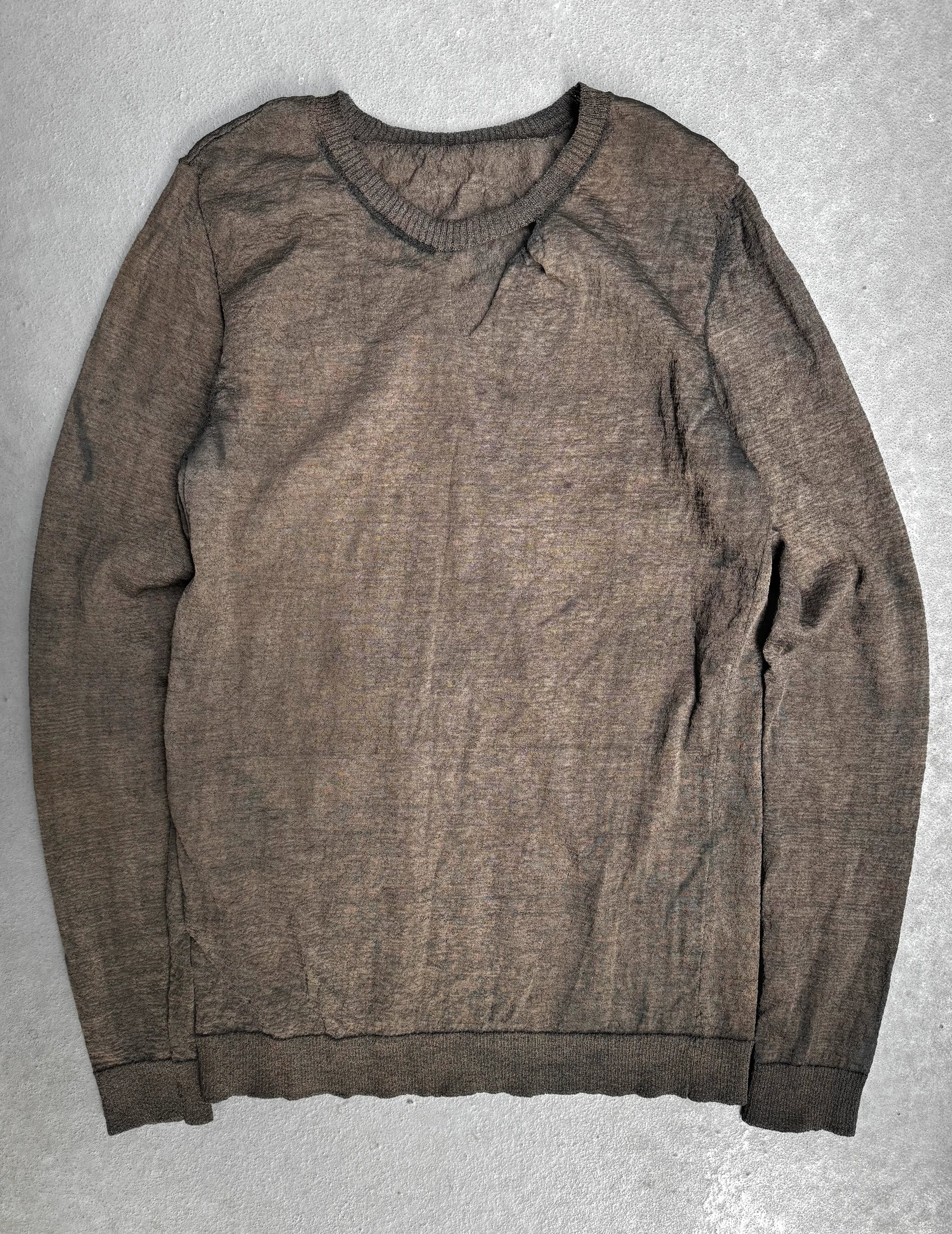 Brown sweater on a gray textured surface