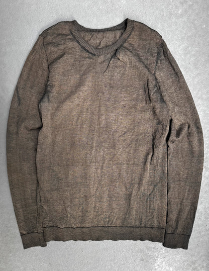 Brown sweater on a gray textured surface
