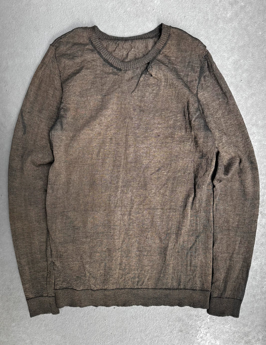 Brown sweater on a gray textured surface