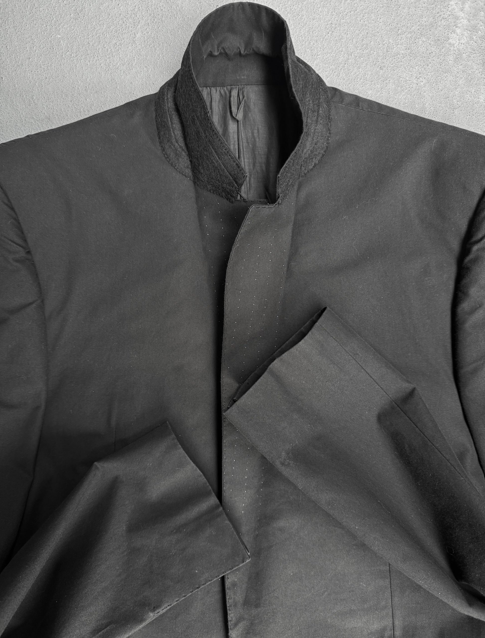 Dark gray coat on a light gray background