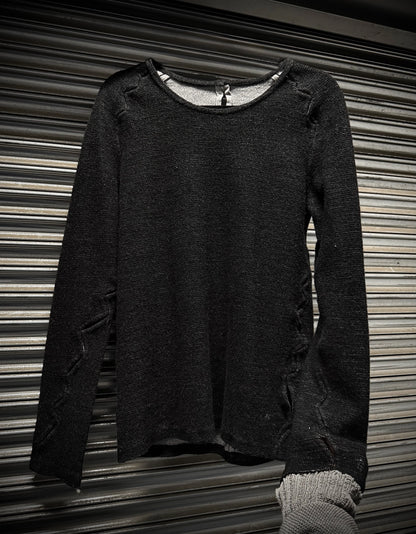 Dark gray sweater on a metallic surface