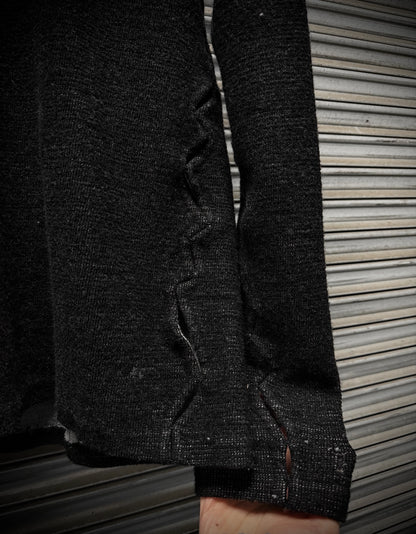 Close-up of a dark textured fabric with a zipper on a wooden surface