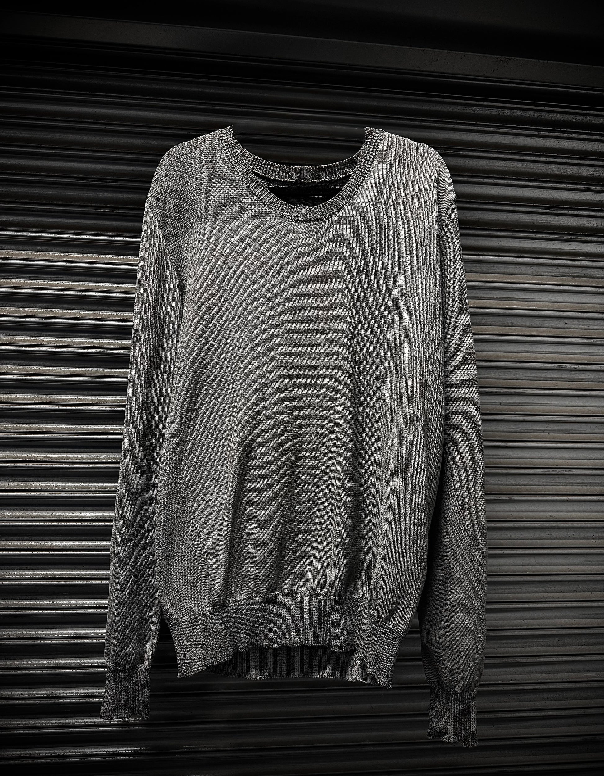 Gray sweater on a metallic surface