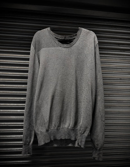 Gray sweater on a metallic surface
