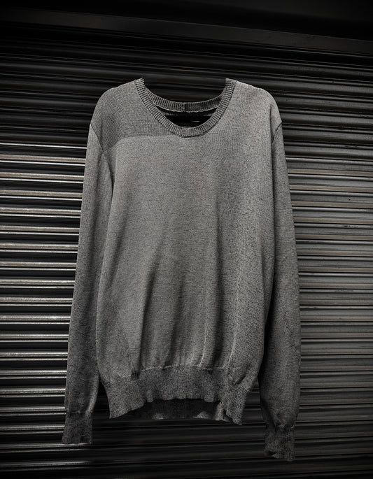 Gray sweater on a metallic surface