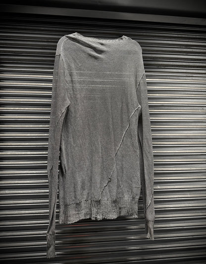 Gray long-sleeve shirt on a metallic surface