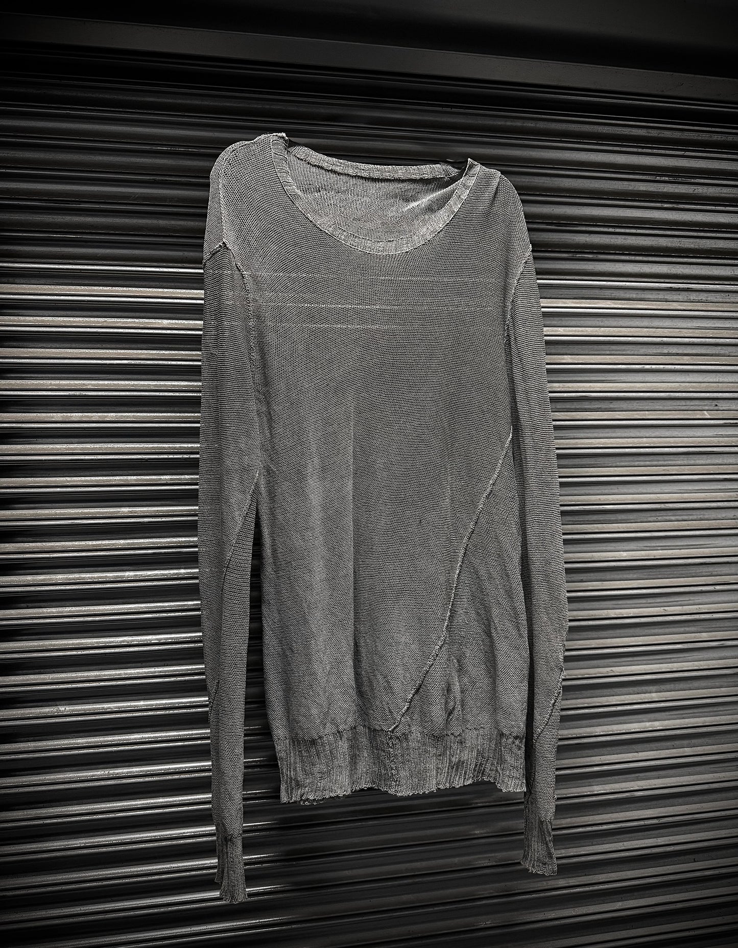 Gray sweater on a metallic surface