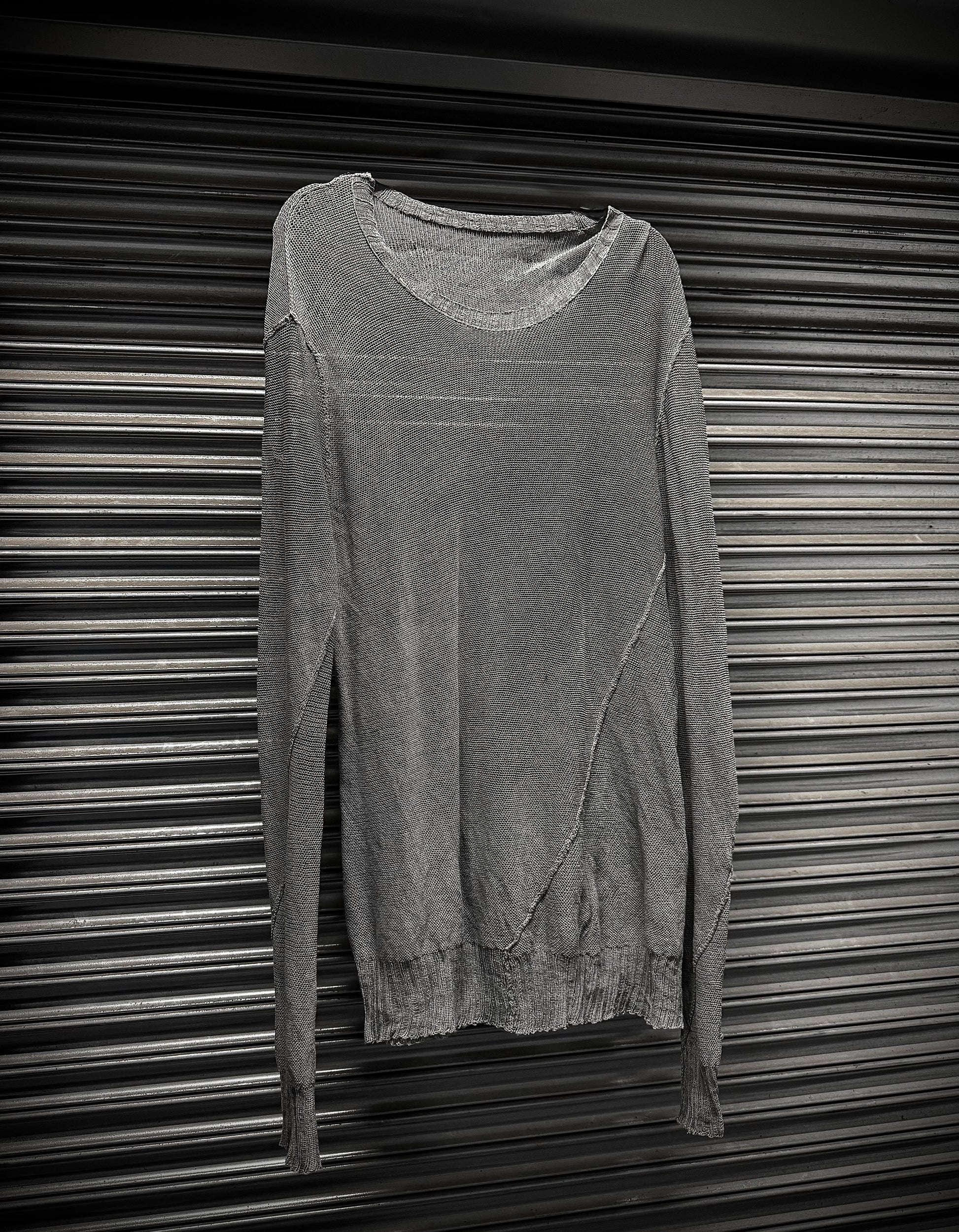 Gray sweater on a metallic surface