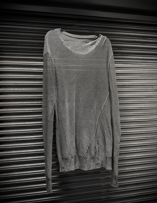 Gray sweater on a metallic surface