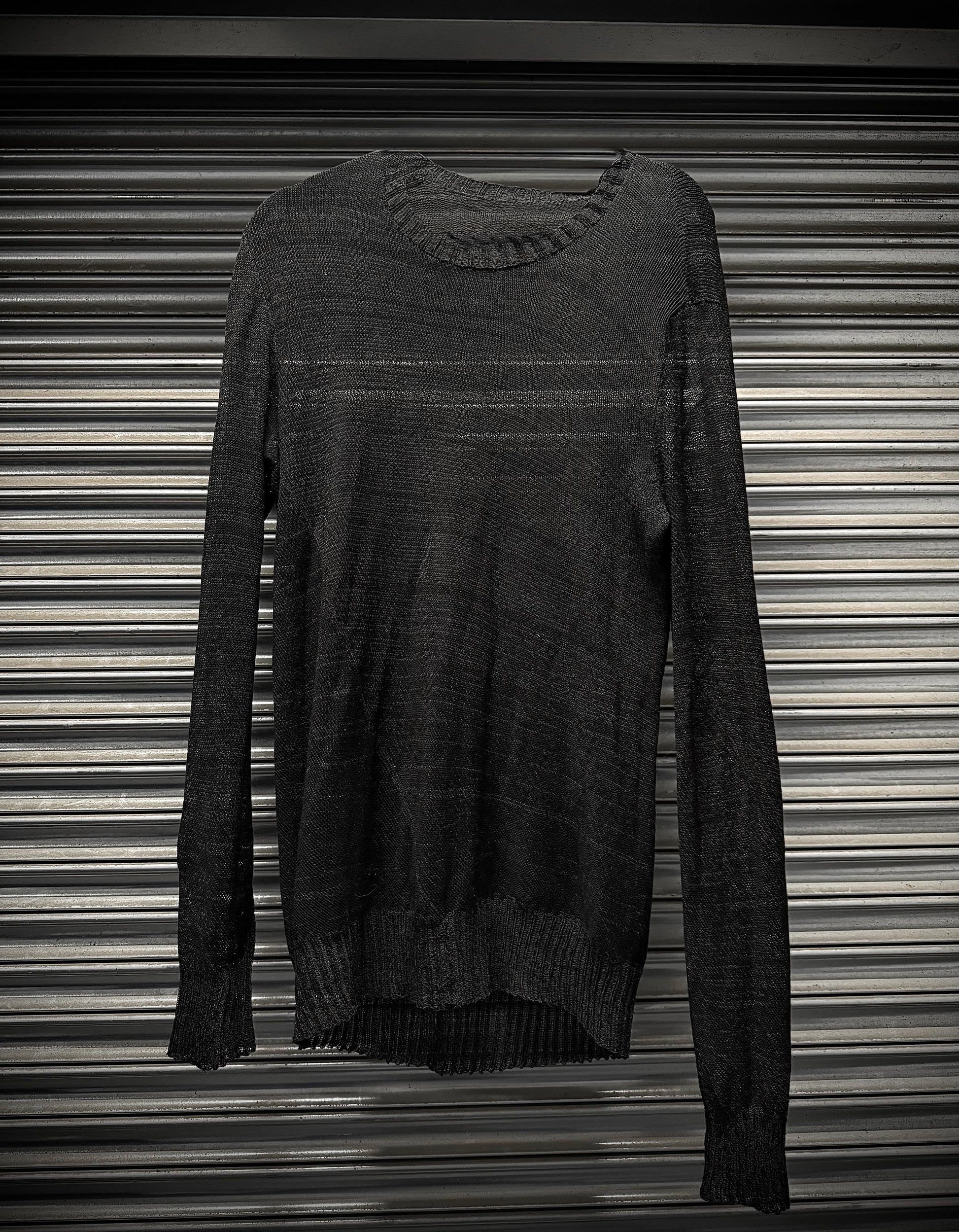 Dark gray sweater on a striped background