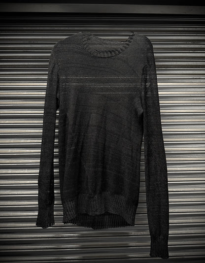 Dark gray sweater on a striped background