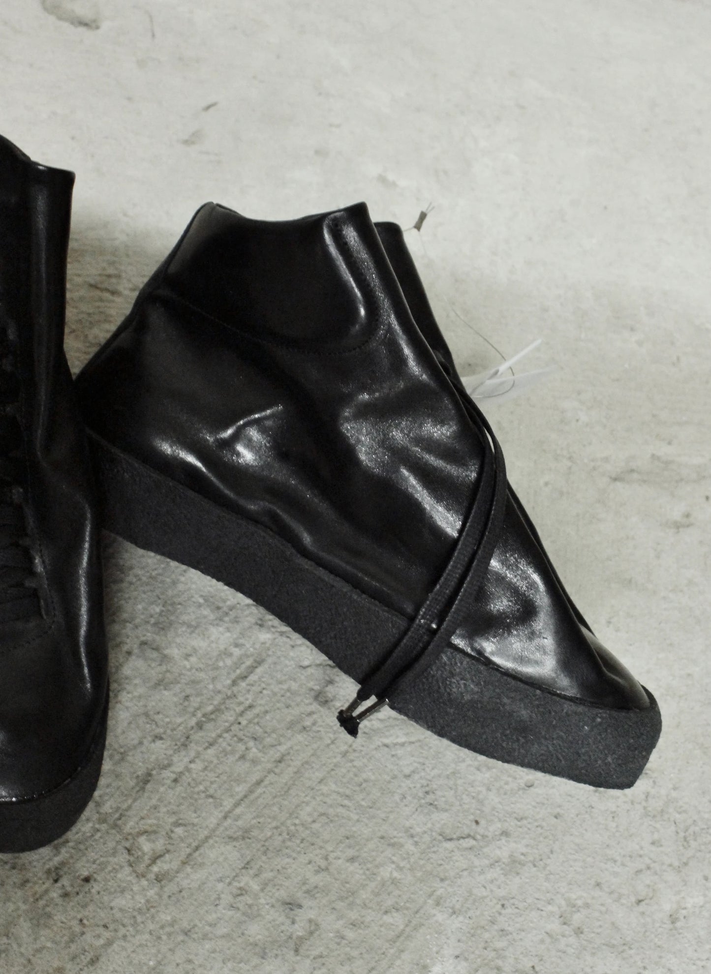 Black leather shoes on a light gray floor