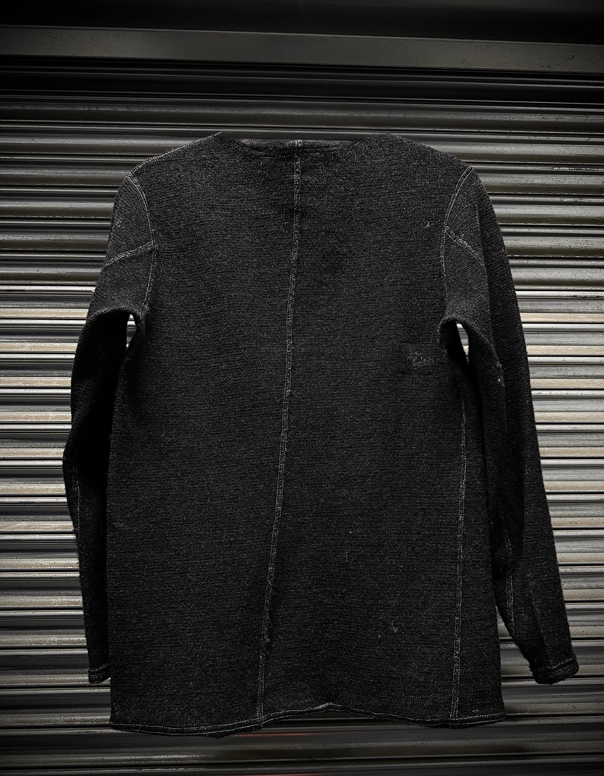 Dark gray jacket on a metallic surface