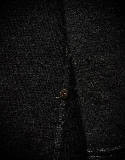Close-up of a dark textured fabric with a button