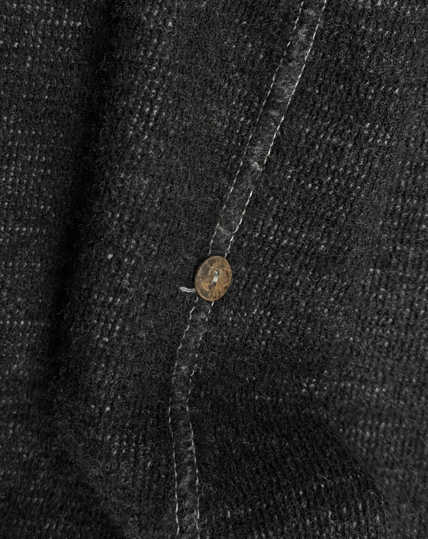 Close-up of a button on a textured fabric surface