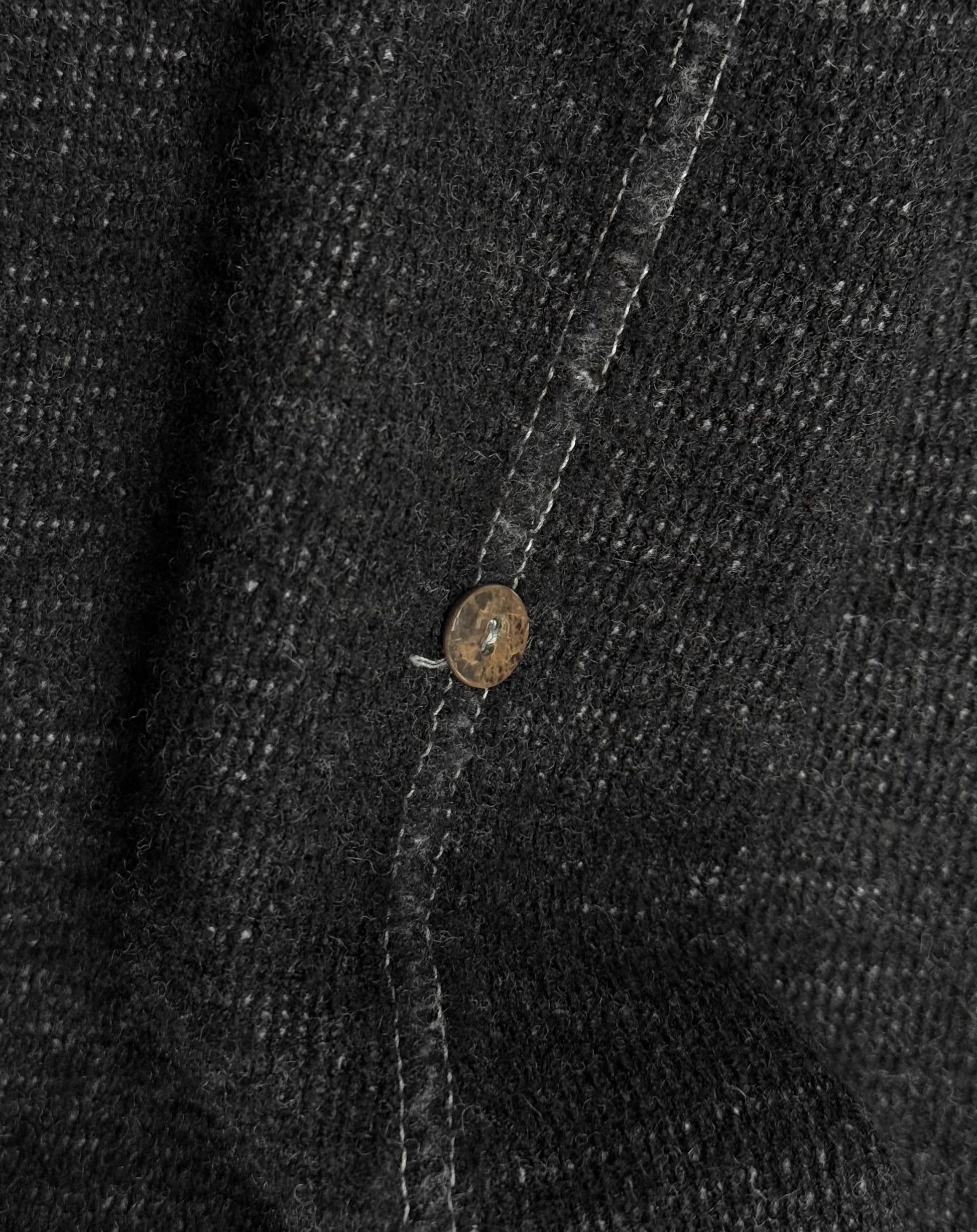 Close-up of a button on a textured fabric surface
