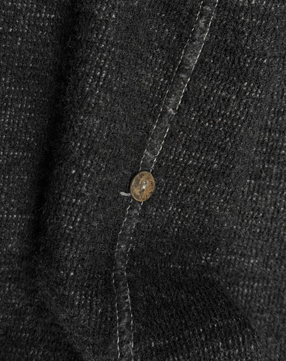 Close-up of a button on a textured fabric surface