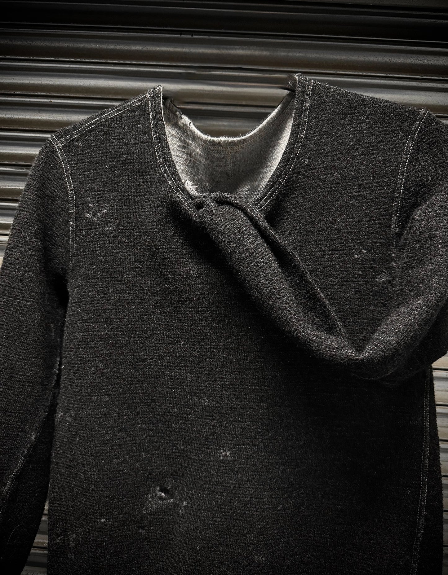 Dark gray coat with a textured texture against a neutral background