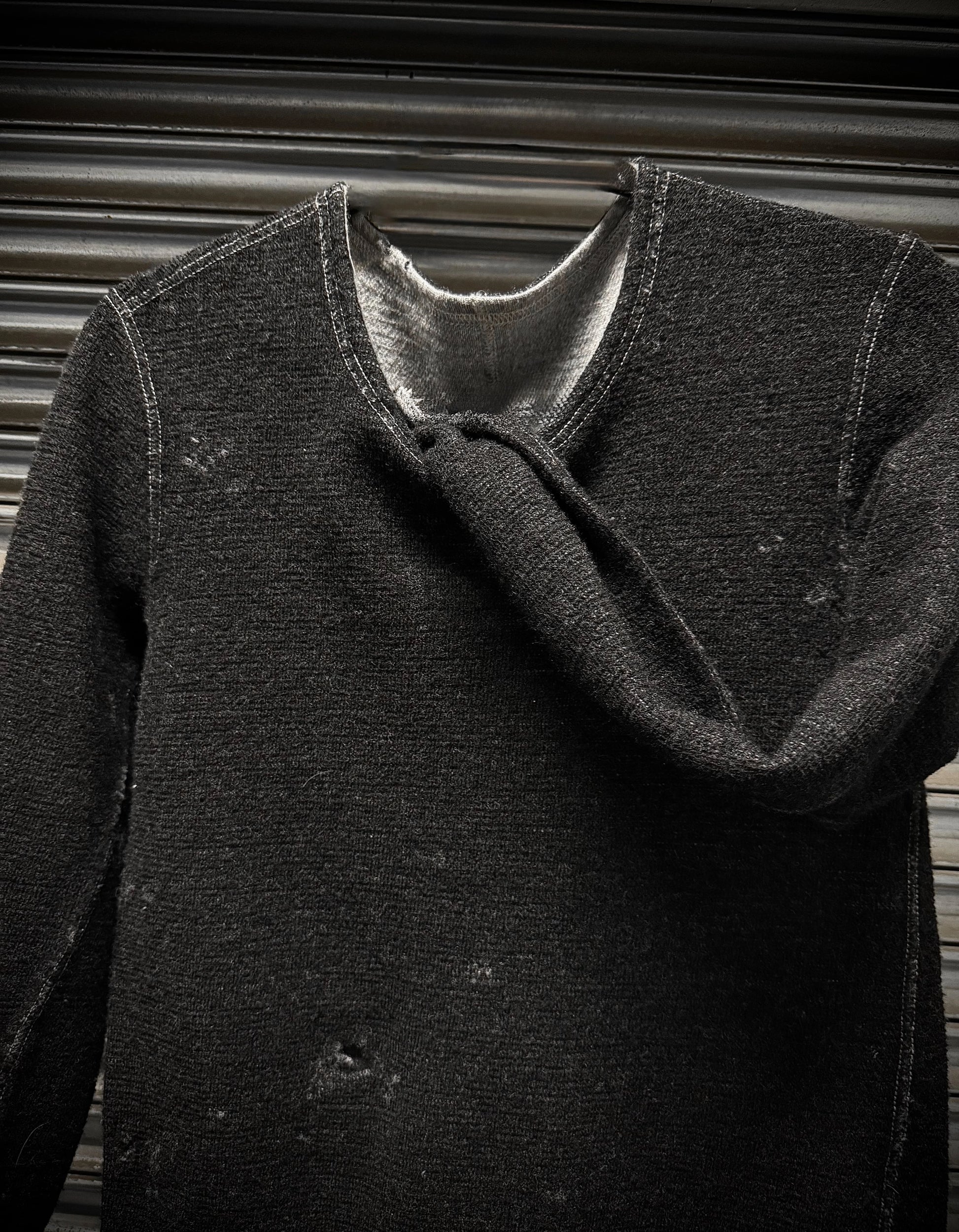 Dark gray coat with a textured texture against a neutral background