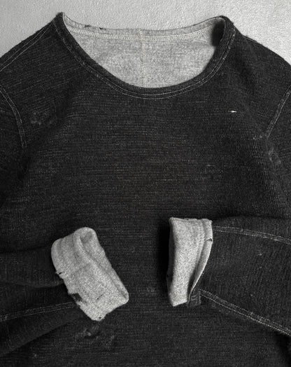 Black denim shirt with a pocket on a textured gray background