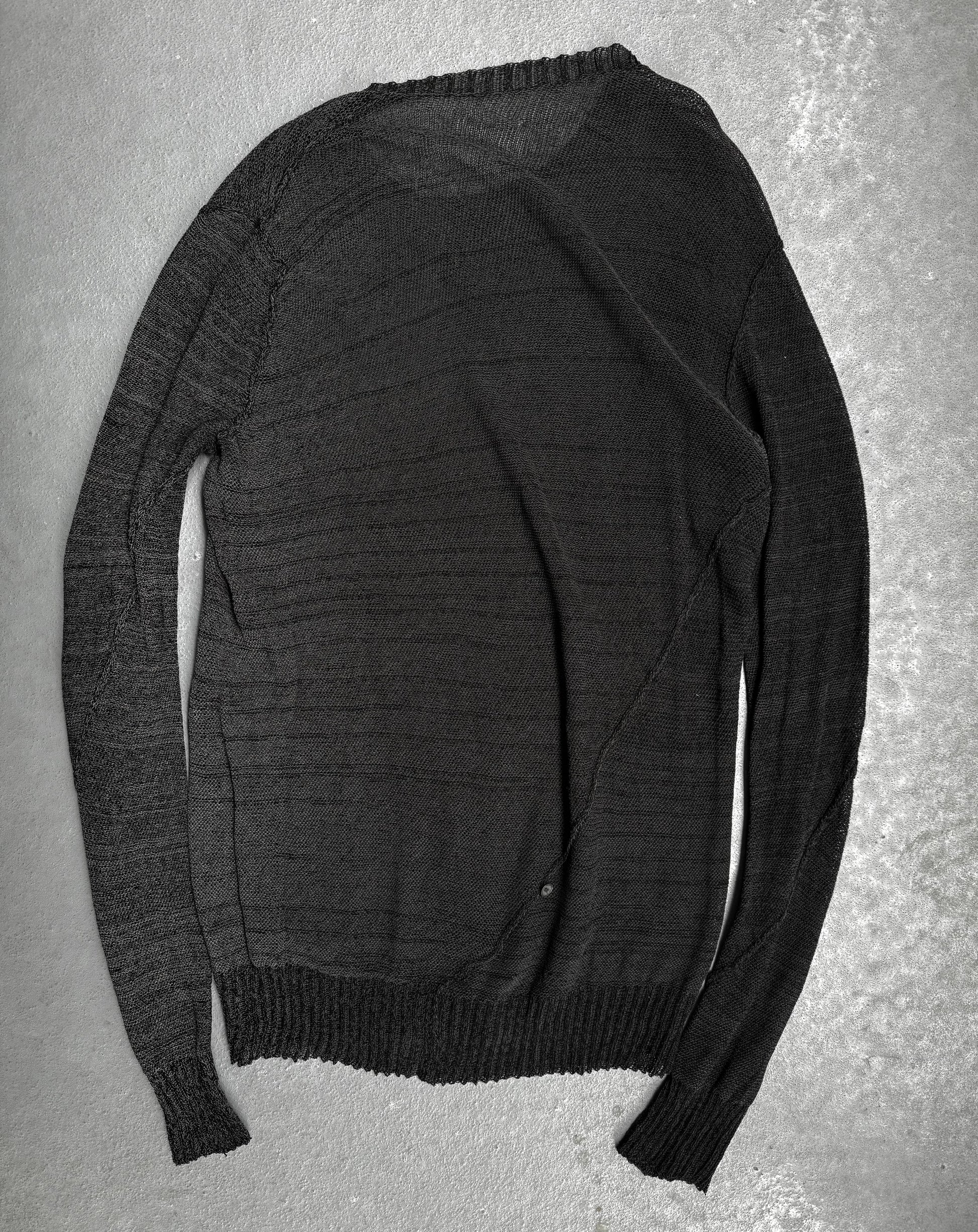Dark gray sweater on a textured gray surface