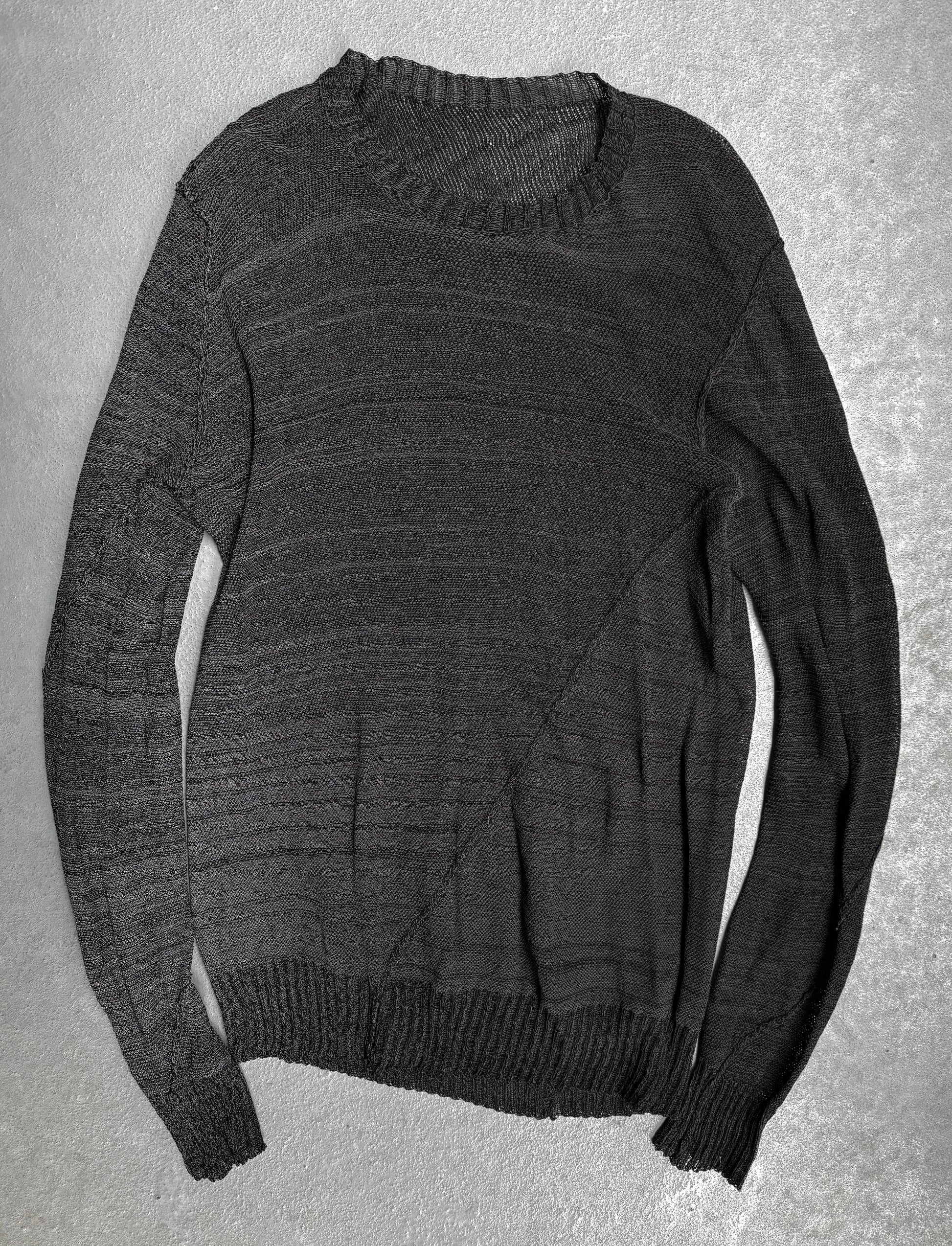 Dark gray sweater on a textured gray background