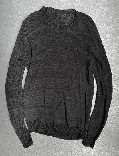 Dark gray sweater on a textured gray background