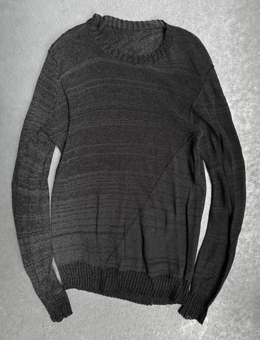 Dark gray sweater on a textured gray background