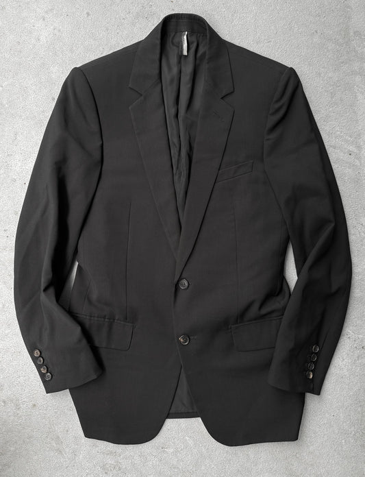 Black blazer on a gray textured background