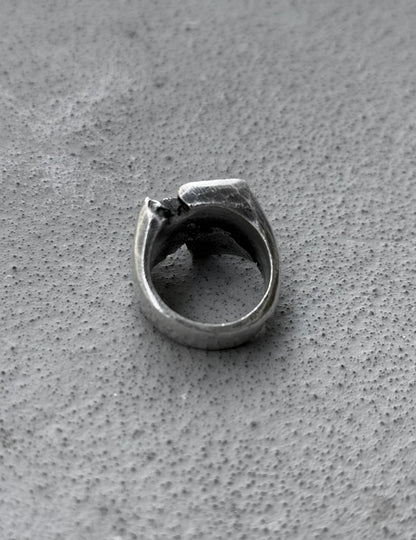 Silver ring on a textured gray surface