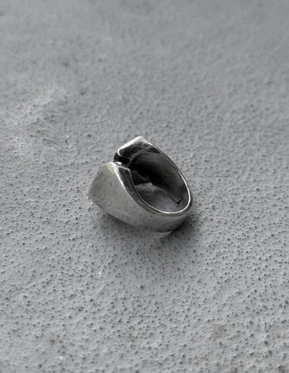 Silver ring on a textured gray surface