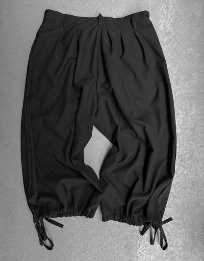 Black pants with drawstring on a gray background