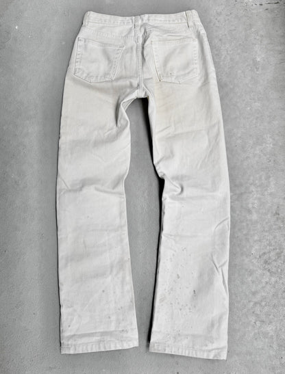 Light-colored jeans on a gray concrete surface
