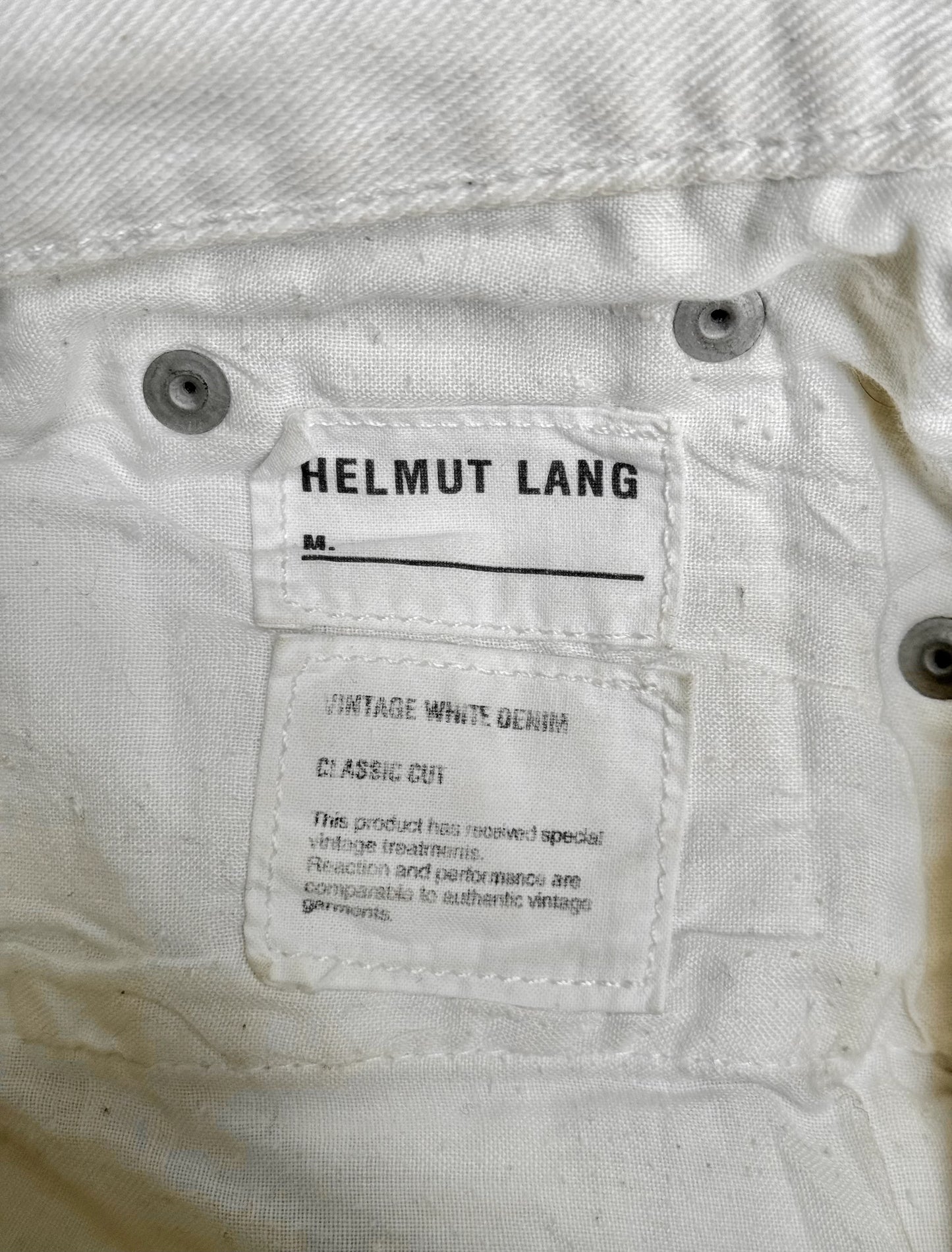 Helmut Lang label on a white denim garment