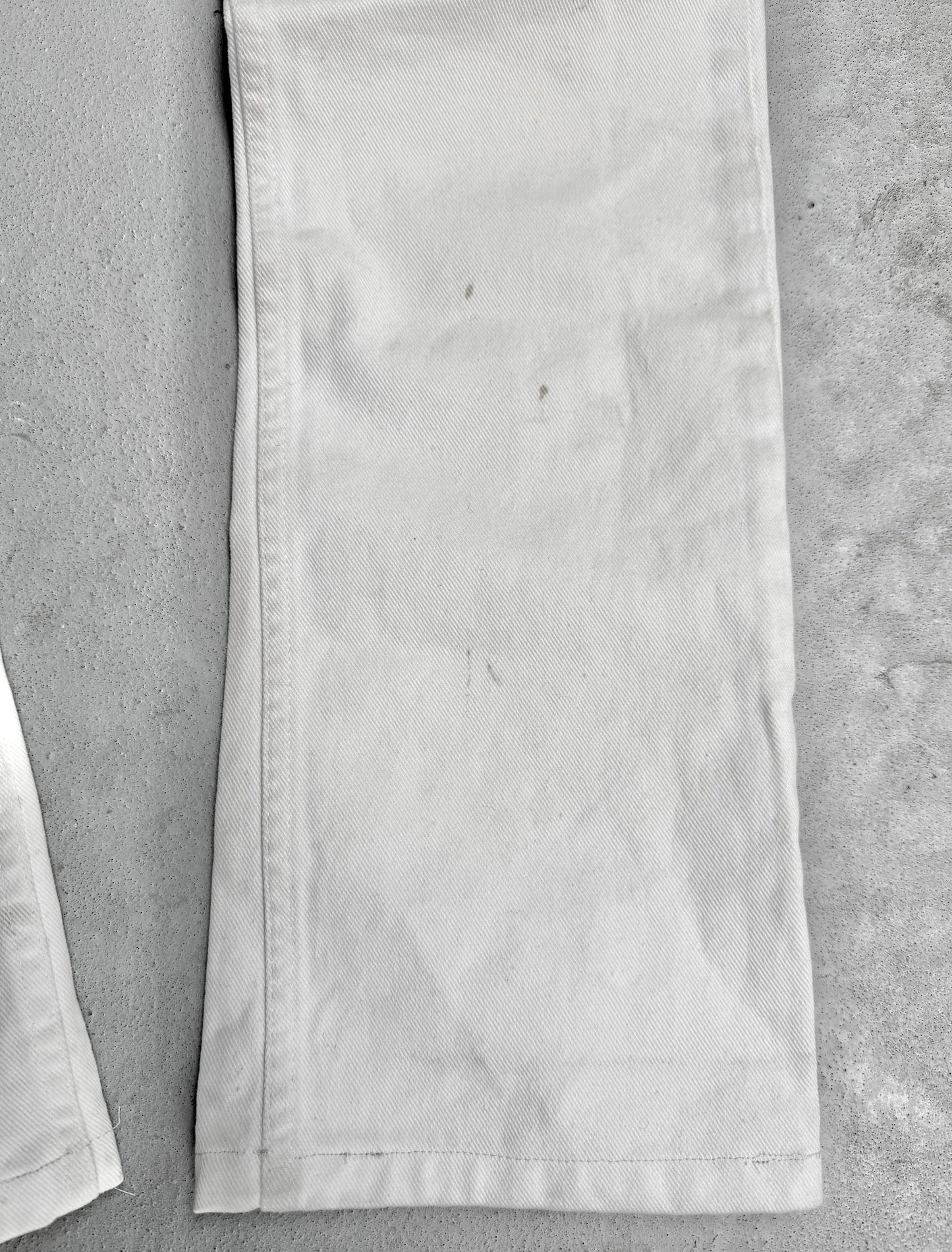 Close-up of a white fabric strip on a gray surface