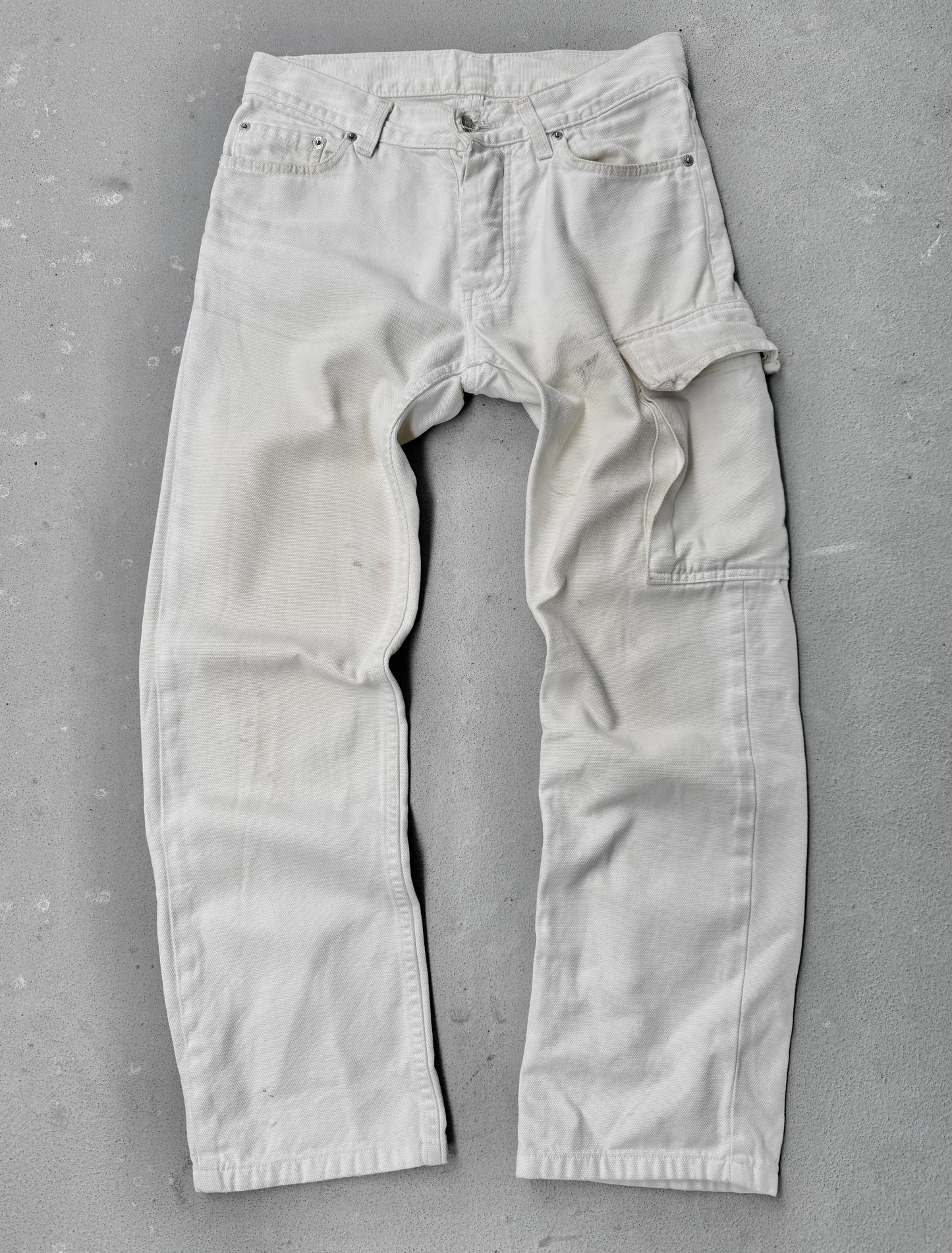 Light-colored pants on a gray concrete floor
