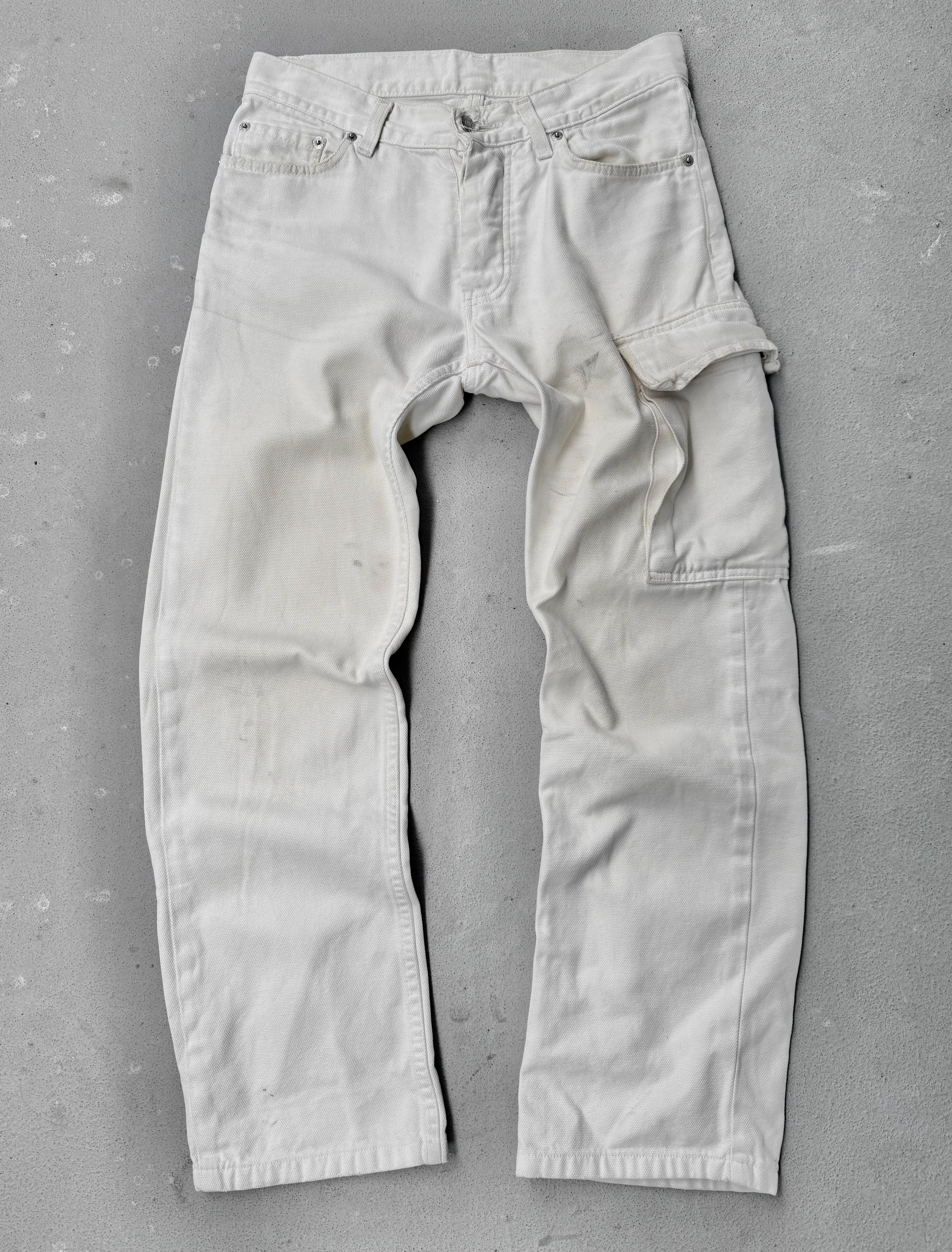 Light-colored pants on a gray concrete floor