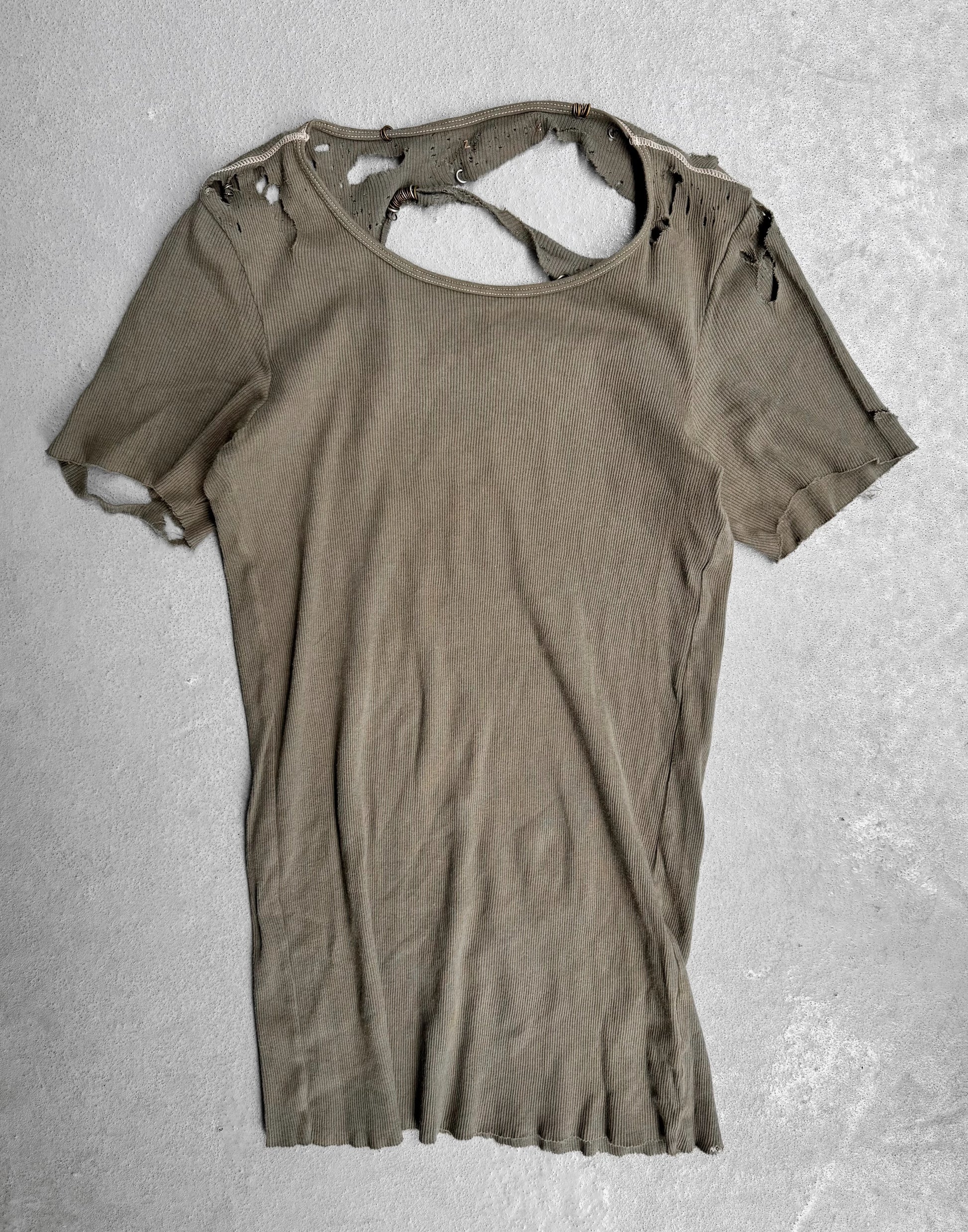 Ripped brown t-shirt on a textured gray background