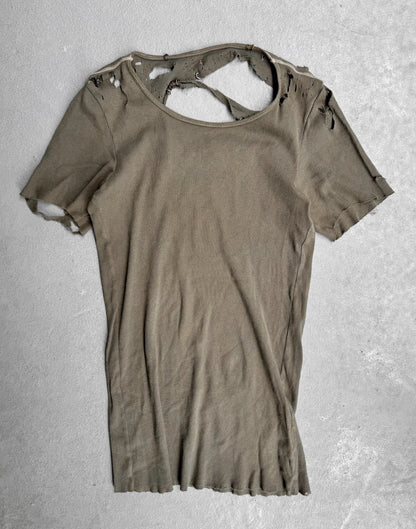 Ripped brown t-shirt on a textured gray background