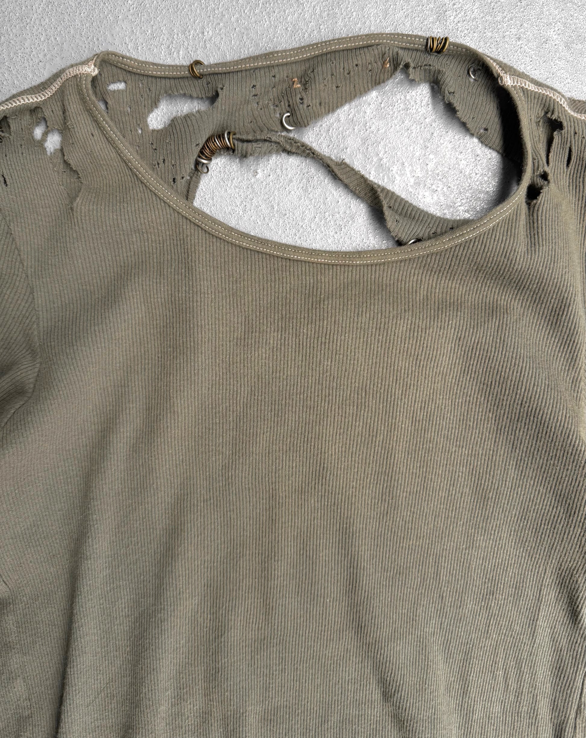 Brown tank top with visible wear and tear on a textured gray background