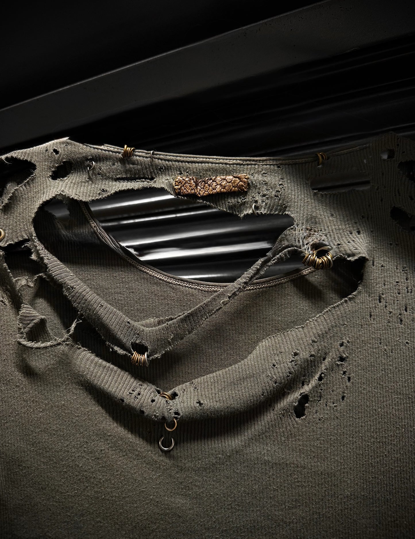 Close-up of a black metal object on a textured surface