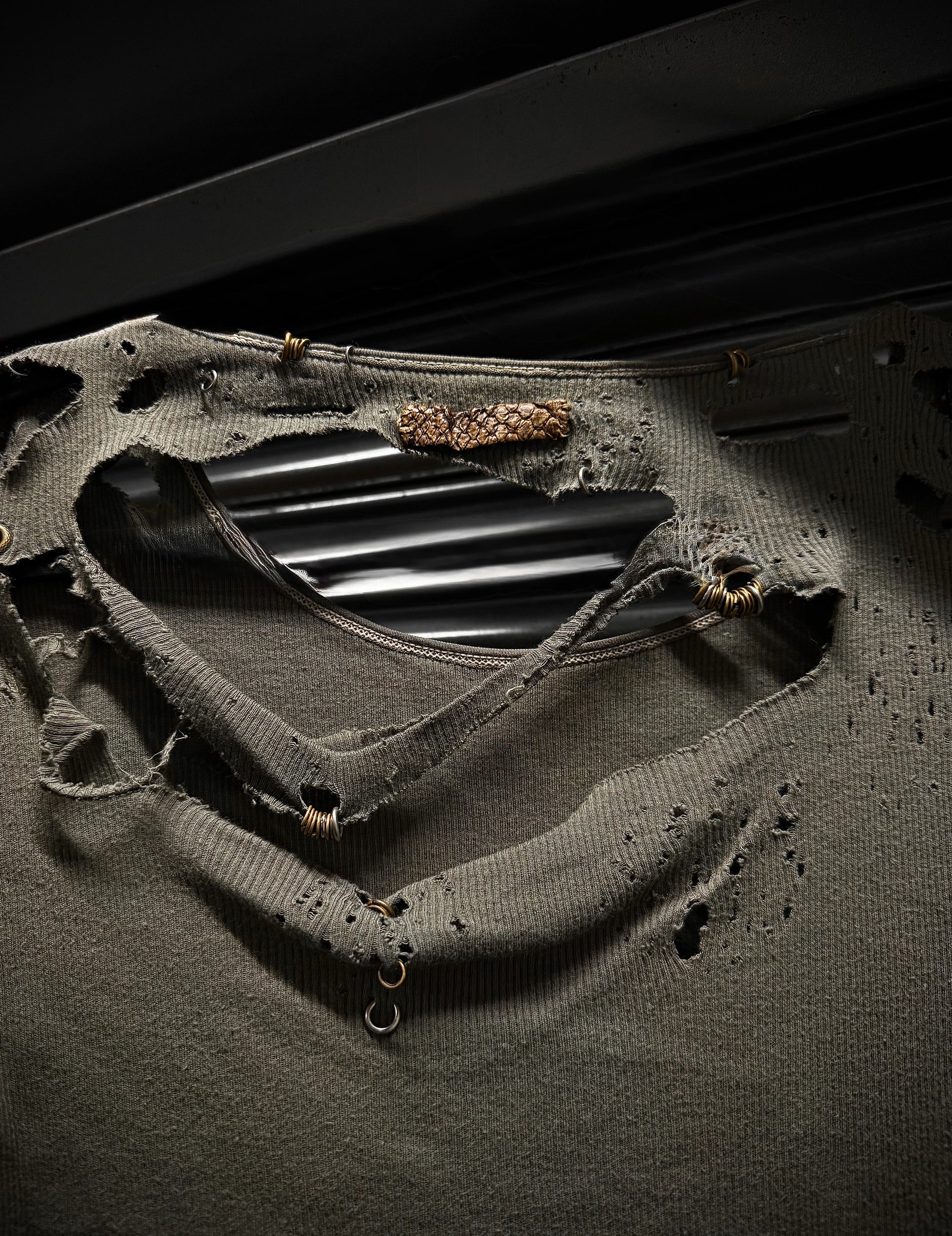 Close-up of a black metal object on a textured surface