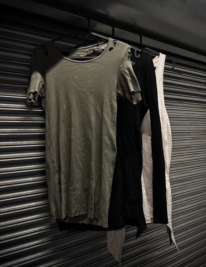 Two dresses hanging on a rack against a metal shutter background