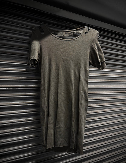 Long-sleeve shirt draped over a short-sleeve shirt against a striped background