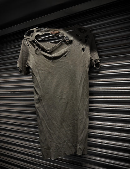 Ripped t-shirt against a corrugated metal background