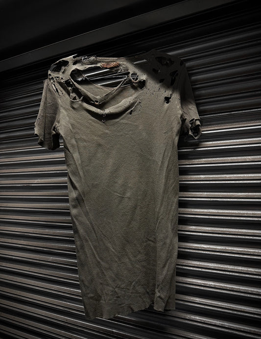 Ripped t-shirt against a corrugated metal background